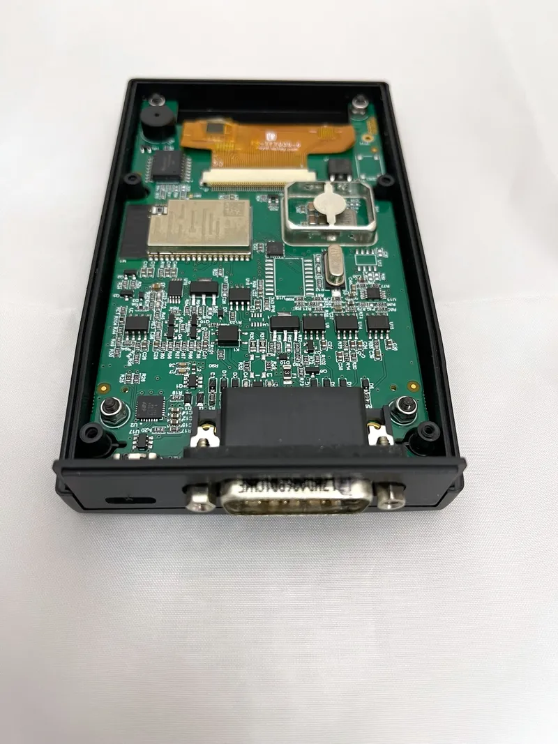 TapCAN opened up, showing the circuit board, ESP32 module and DB26 connector